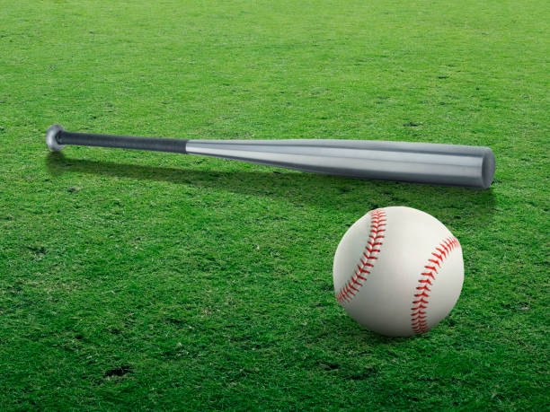 istock Baseball bat and ball isolated on the clear green grass 1354158991