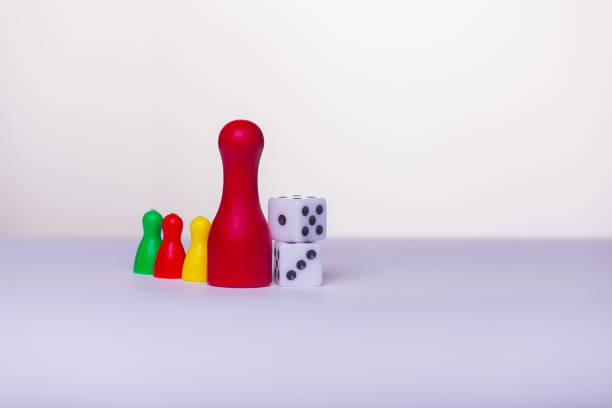 istock Start play a game - board game concept. Many figures, , dice and sandglass. White background free space for text 1354159228