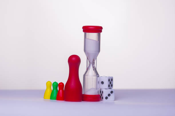 istock Start play a game - board game concept. Many figures, , dice and sandglass. White background free space for text 1354159231