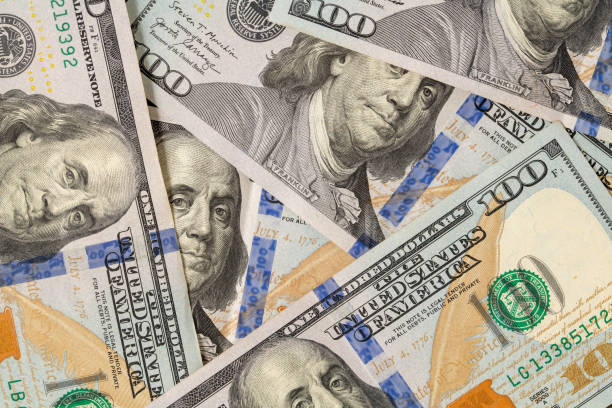 istock 100 US dollars in a pile that fills the entire screen 1354165909
