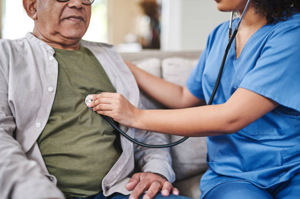 istock Cropped shot of an unrecognisable nurse sitting with her senior patient and using a stethoscope during a checkup at home 1354166350