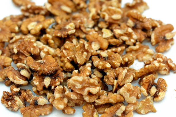 istock Walnuts, a bunch of peeled walnuts on a white background 1354166624