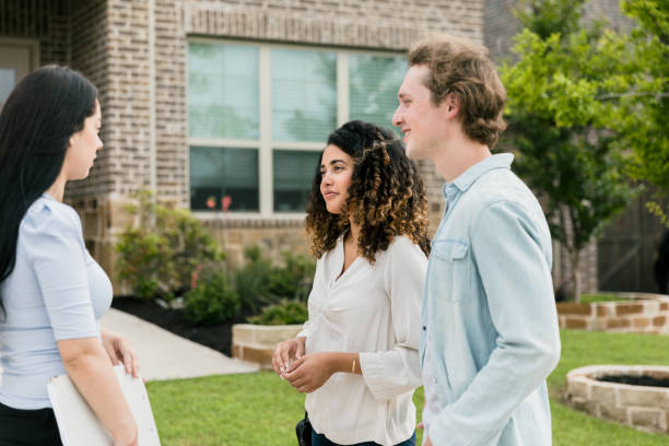 istock Potential home owners talking with Real Estate Agent 1354166823