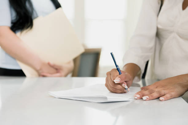 istock Unrecognizable woman signs lease agreement 1354166860
