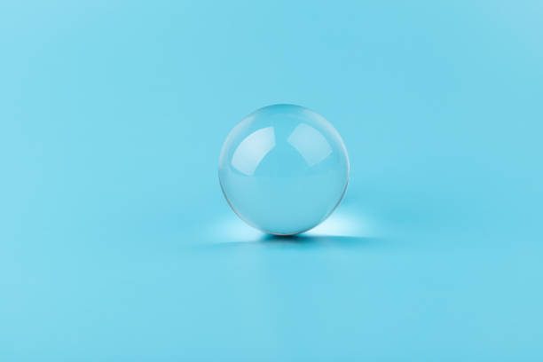 istock Crystal glass ball sphere transparent on blue background. 1354166927