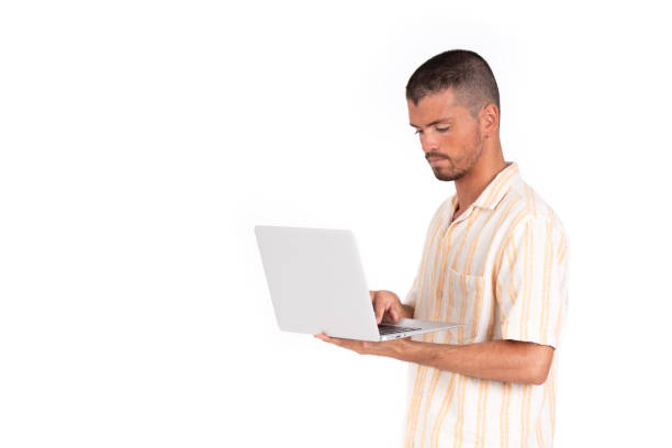istock Caucasian young man with grey laptop on a white background 1354167092