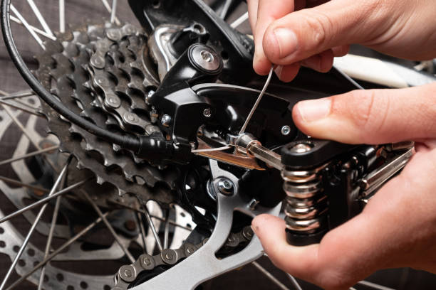 installation of a cable for gear shifting on a bicycle stock photo