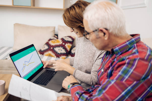 istock Mature economist explaining some documents to her senior client 1354168993