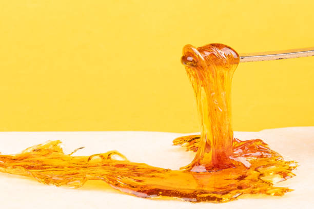 yellow orange cannabis concentrate wax close up, high thc dab resin stock photo