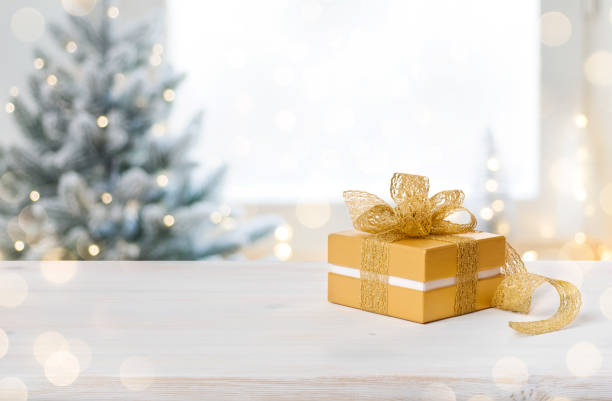 Gift box on table with space on blurred Christmas background stock photo