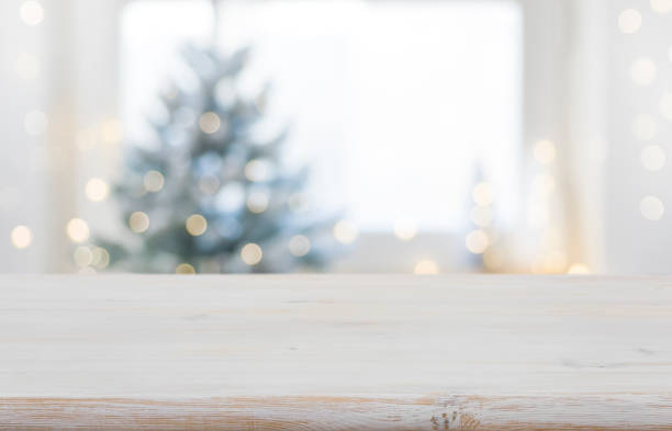istock Empty wooden table in front of blurred winter festive background 1354169552