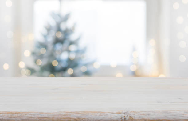 Empty wooden table in front of blurred winter festive background stock photo