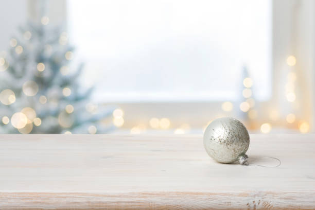 istock Xmas ball on table in front of defocused festive background 1354169574