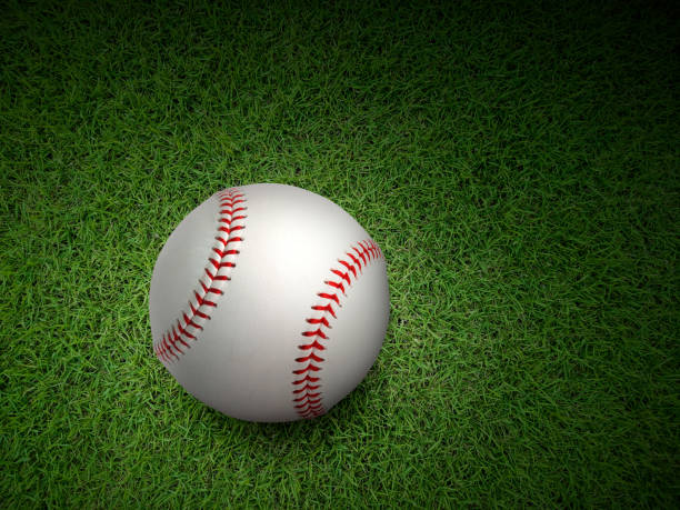 istock Baseball on the clear green grass turf close-up 1354169663
