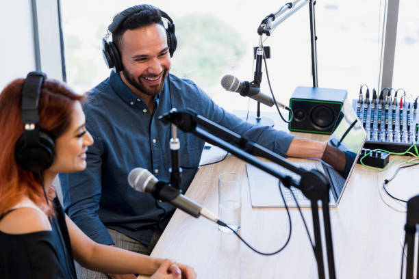 istock Radio show hosts in studio smile at unseen guest 1354169920