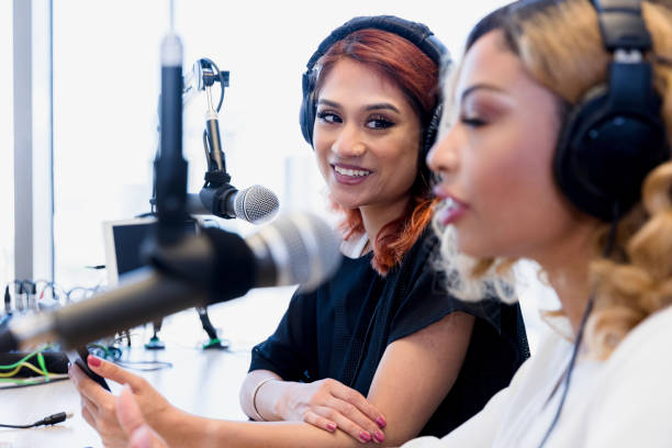 istock Woman smiles at female co-host 1354169927