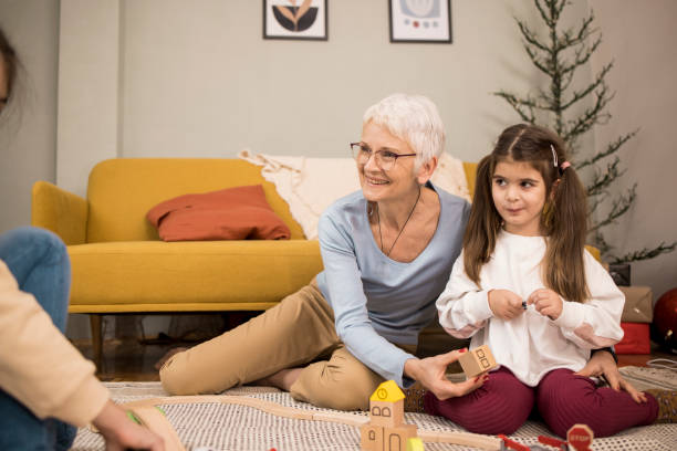 istock Senior woman enjoying playing with her two granddaughters 1354171067