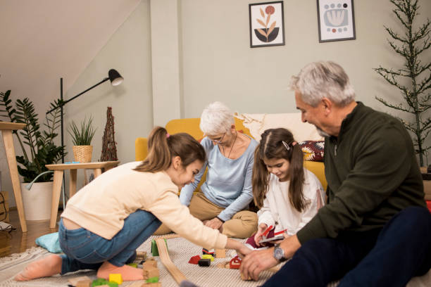 istock Senior couple enjoying playing with their two granddaughters 1354171069