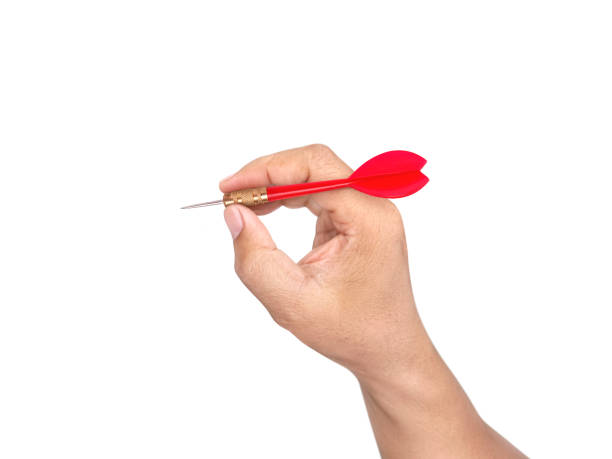 istock hand holding darts arrow isolated on white background. concept marketing target 1354171149