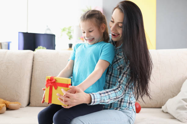 istock Cheerful child girl open present box and express happy emotions 1354171342