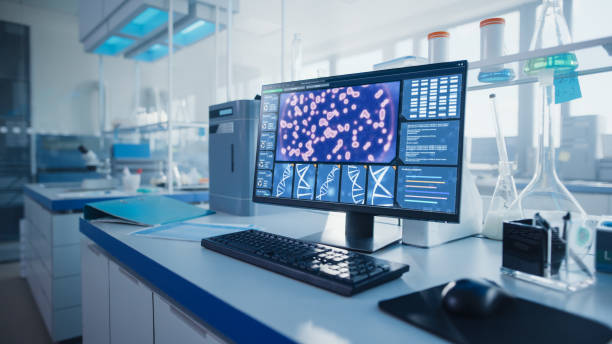 istock Modern Medical Research Laboratory with Computer, Microscope, Glassware with Biochemicals on the Desk. Scientific Lab Biotechnology Development Center Full of High-Tech Equipment. 1354171879