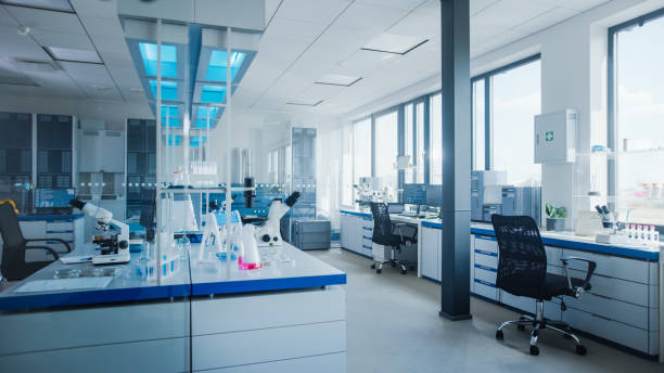 istock Modern Medical Research Laboratory with Computer, Microscope, Glassware with Biochemicals on the Desk. Scientific Lab Biotechnology Development Center Full of High-Tech Equipment. 1354171885