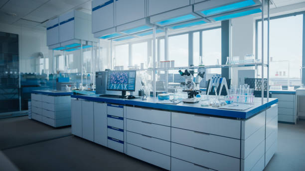 istock Modern Medical Research Laboratory with Computer, Microscope, Glassware with Biochemicals on the Desk. Scientific Lab Biotechnology Development Center Full of High-Tech Equipment. 1354171888