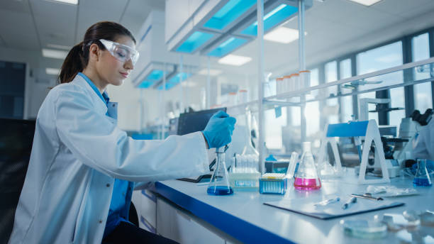 istock Modern Medical Research Laboratory: Female Scientist Working with Micro Pipette, Analysing Biochemicals Samples. Advanced Scientific Lab for Medicine, Microbiology Development. 1354172435