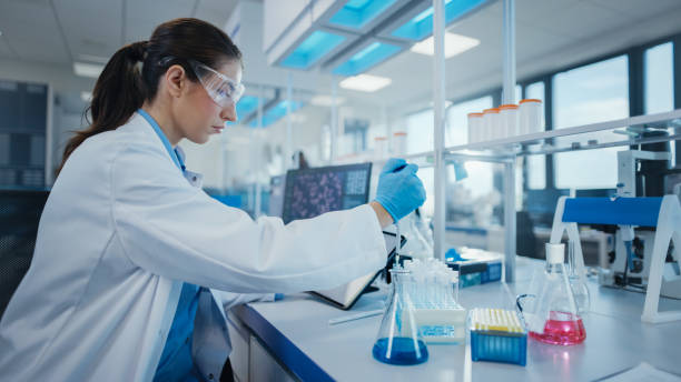 istock Modern Medical Research Laboratory: Female Scientist Working with Micro Pipette, Analysing Biochemicals Samples. Advanced Scientific Lab for Medicine, Microbiology Development. 1354172445