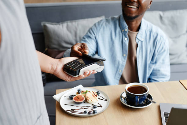 istock Man Paying For Coffee In Cafe 1354172516