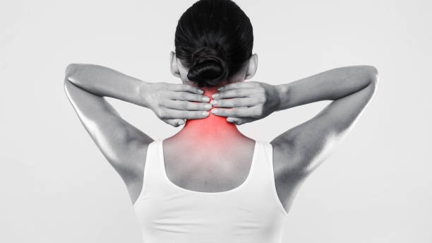 istock Back view of unrecognizable woman touching and massaging her neck 1354172597
