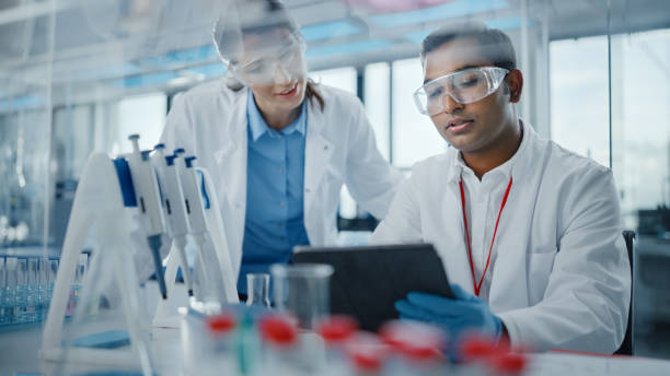 istock Modern Medical Research Laboratory: Two Scientists Working Together Analysing Samples, Discussing Innovative Technology. Advanced Scientific Lab for Medicine, Biotechnology, Molecular Biology 1354172638