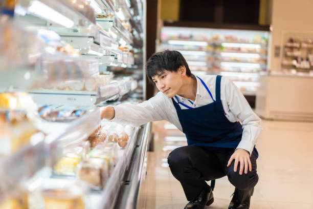 istock Young staffs working at a supermarket 1354173368