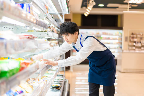 young staffs working at a supermarket - sales clerk imagens e fotografias de stock