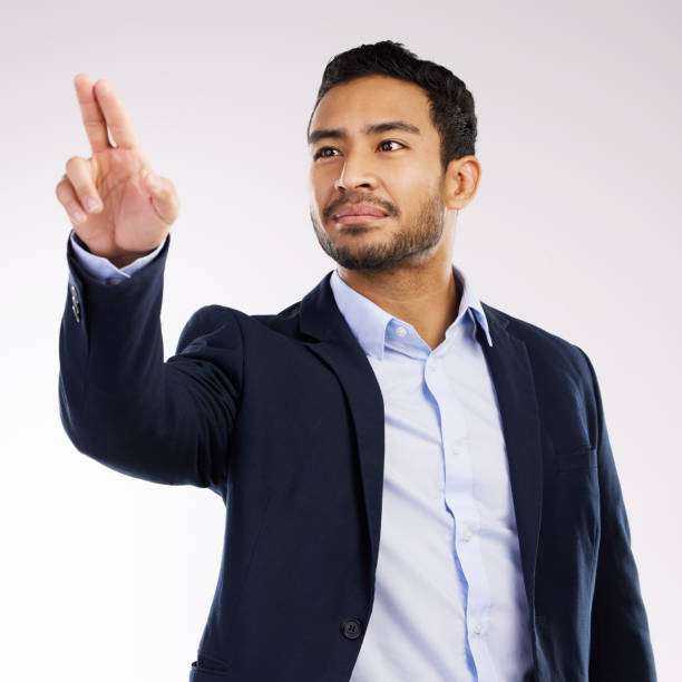 istock Studio shot of a young businessman connecting to a user interface against a white background 1354173380