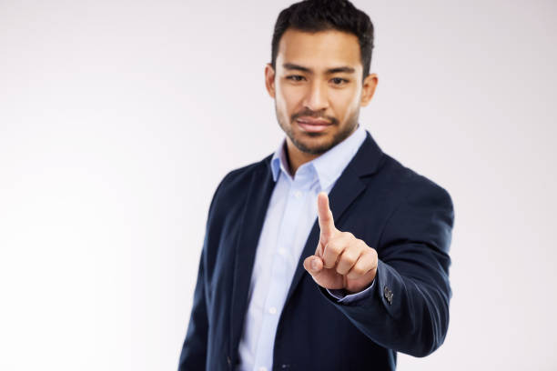 istock Studio shot of a young businessman connecting to a user interface against a white background 1354173387