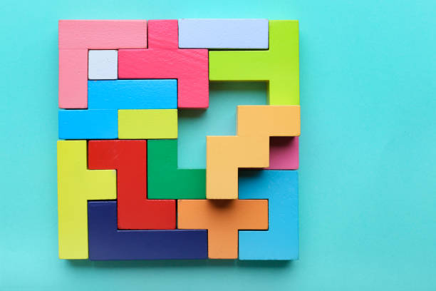 istock Multicolored puzzle, hand and cubes on a mint background 1354173851