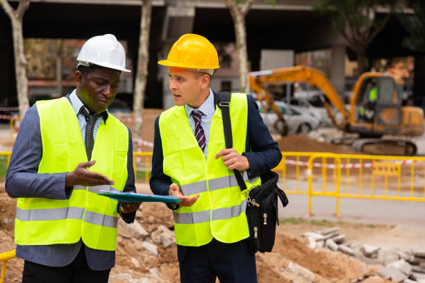 istock Architect tells engineer where to dig a trench to lay pipe 1354174985