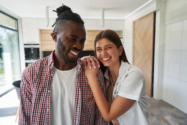 istock Pleased man and smiling woman standing in kitchen 1354175704