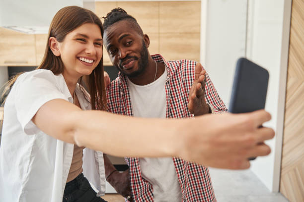istock Joyful woman and man taking selfies indoors 1354175740