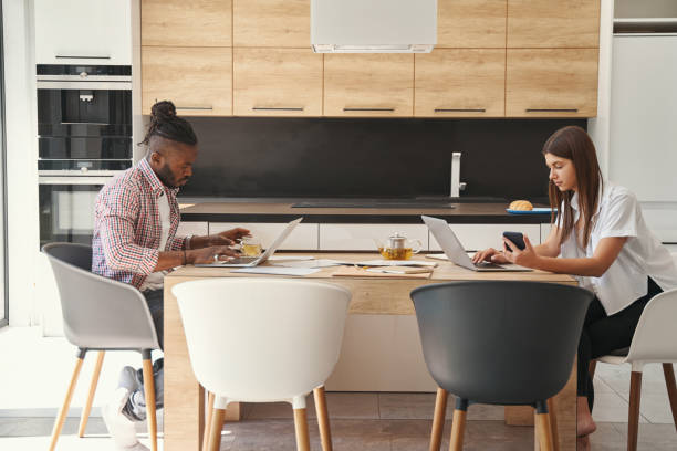 istock Two concentrated young freelancers sitting at laptops 1354175749