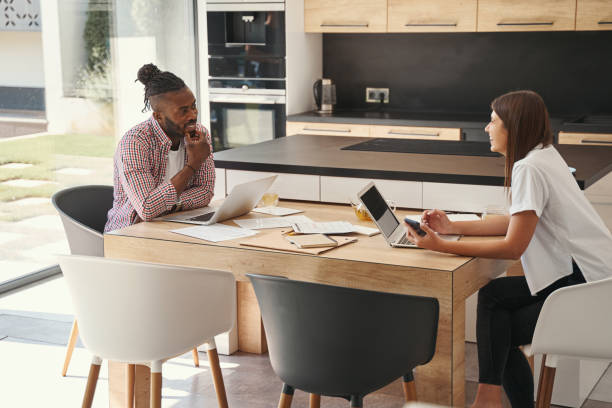 istock Two telecommuters at desk smiling at each other 1354175754