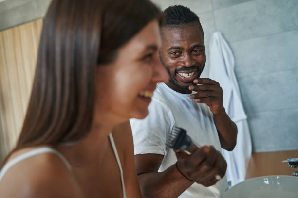 istock Cheerful guy and happy lady standing in bathroom 1354175822