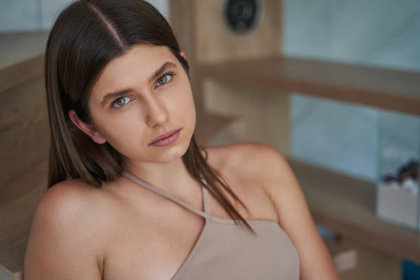 istock Despondent lady sitting on stairs and staring ahead 1354175914