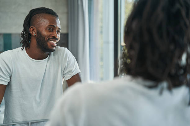 istock Joyous man admiring his appearance in bathroom 1354175927