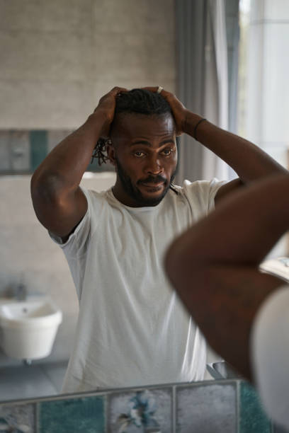 istock Serious focused African American guy standing in bathroom 1354175929