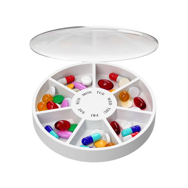 istock Round pill box with different tablets and vitamins for a week. Medication organiser. 3d rendering. 1354176386