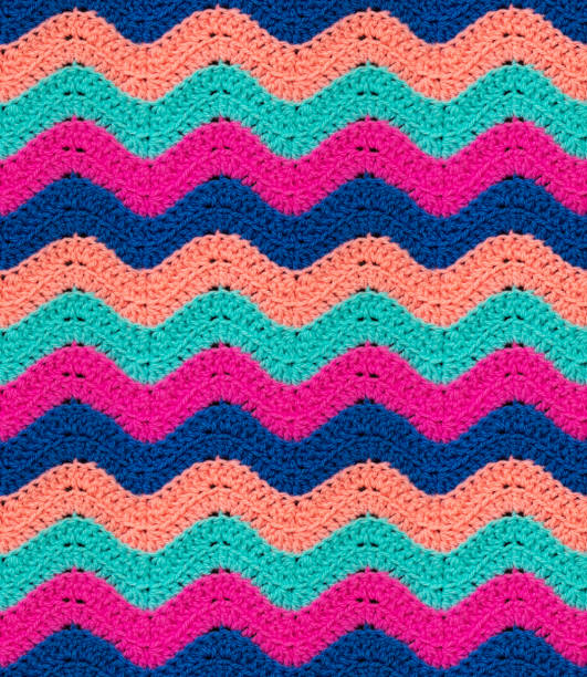 istock Seamless knitted pattern in the form of zigzags is crocheted with multi-colored threads. Acrylic baby yarn. 1354176389