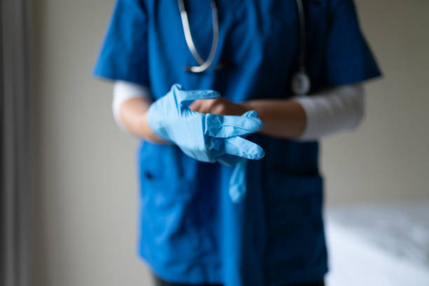 Health care staff wearing gloves and face sheld Health care staff wearing gloves and face sheld sheld stock pictures, royalty-free photos & images