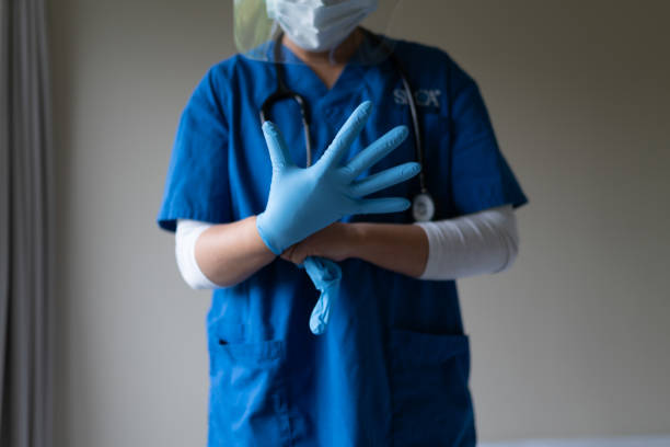 Health care staff wearing gloves and face sheld Health care staff wearing gloves and face sheld sheld stock pictures, royalty-free photos & images